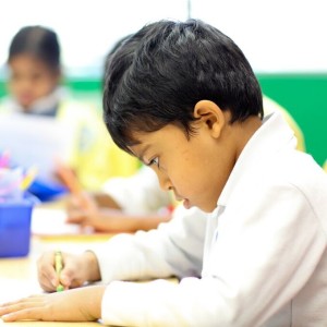 Montessori child coloring to express creativity and enhance fine motor control.